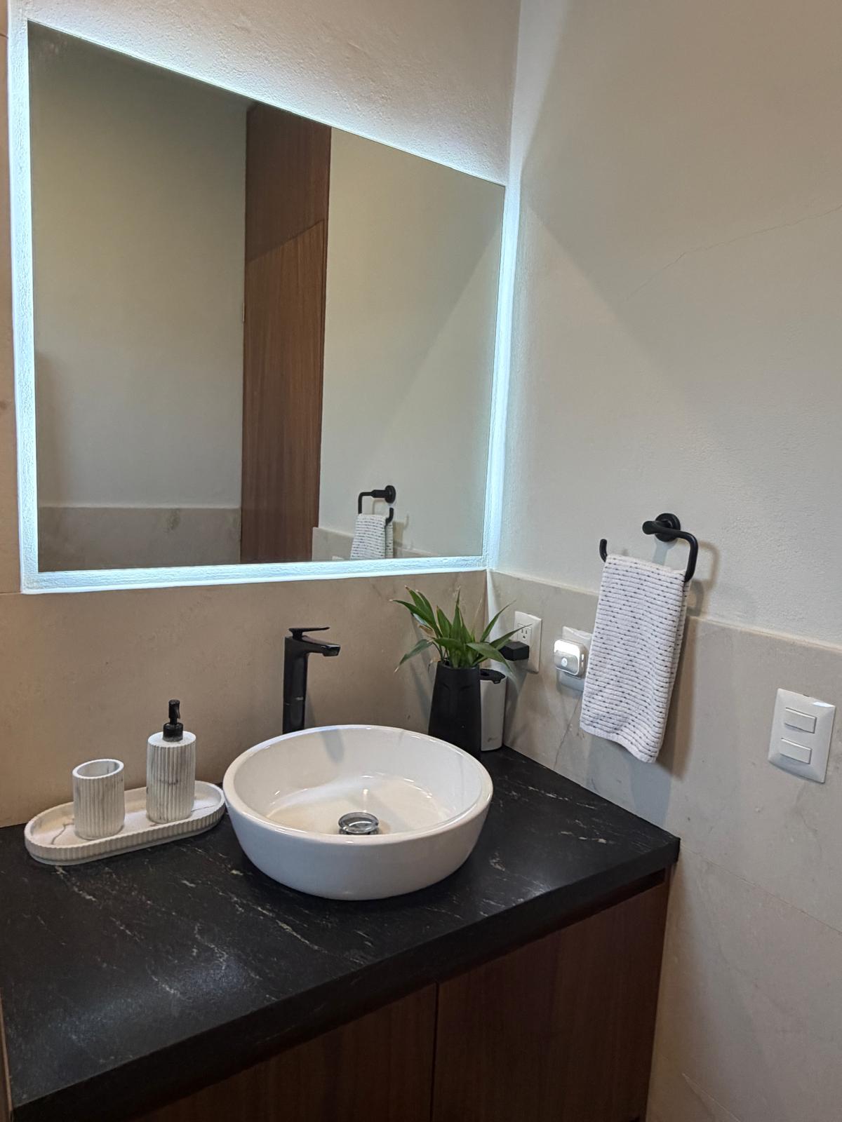 Guest bathroom vanity with black fixtures