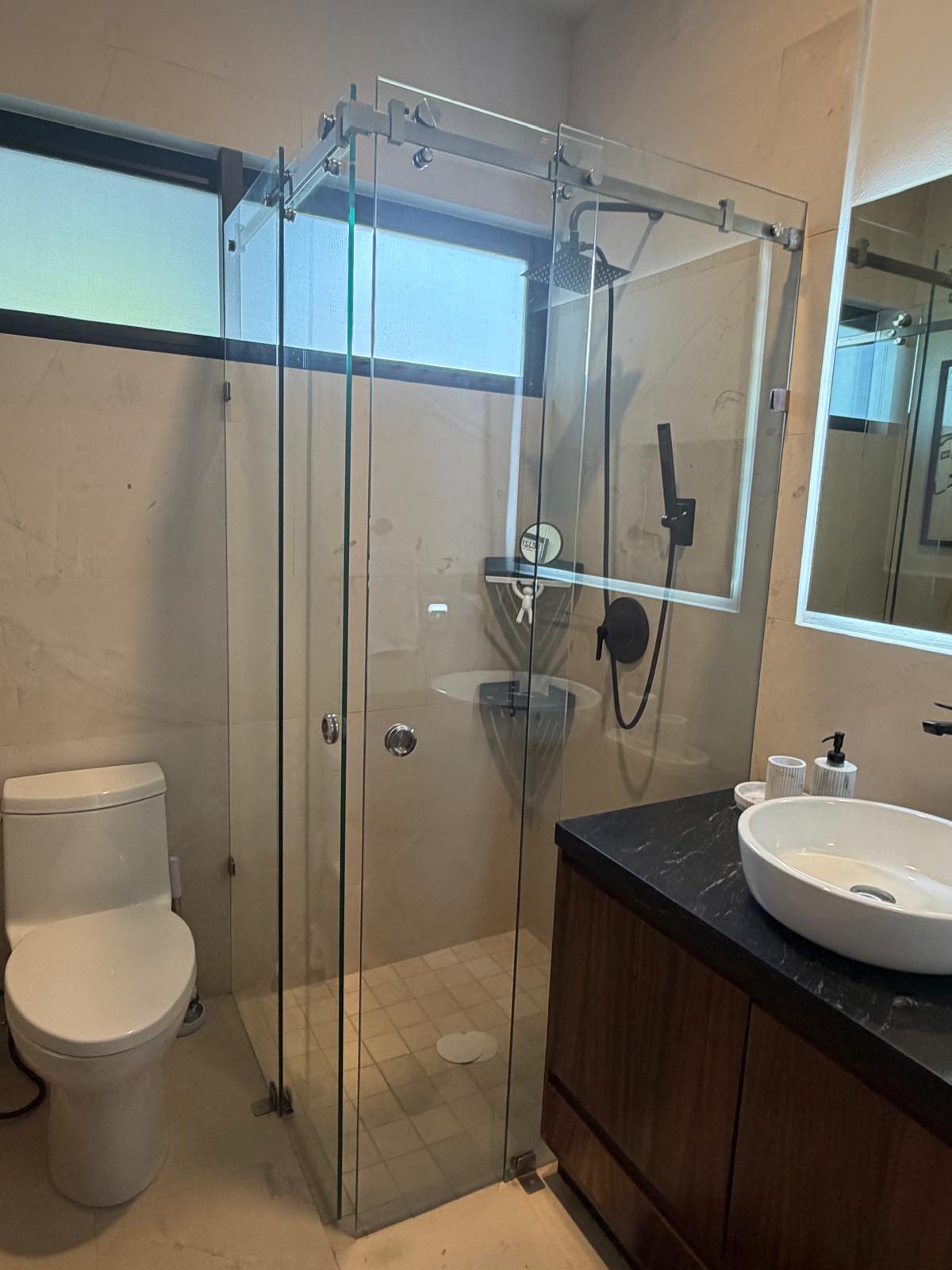 Guest bathroom glass-enclosed walk-in shower